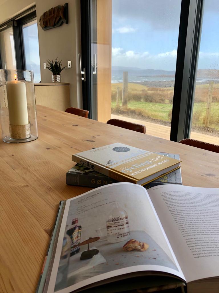 Books on the dining table, one open